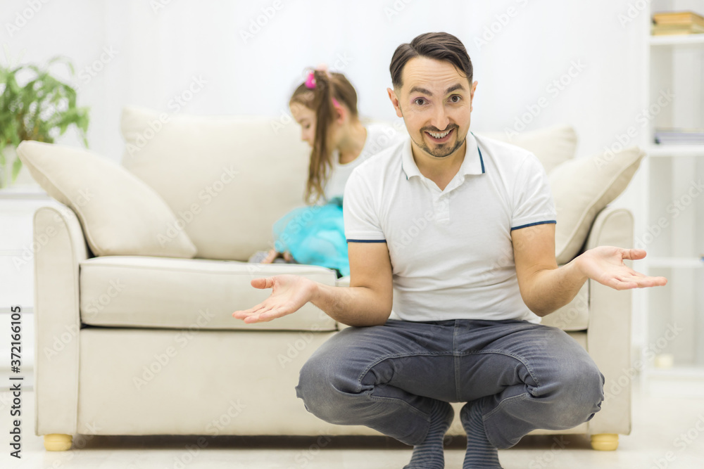 Cute little girl and her handsome father smiling at home. Cute little girl and her handsome father smiling at home.