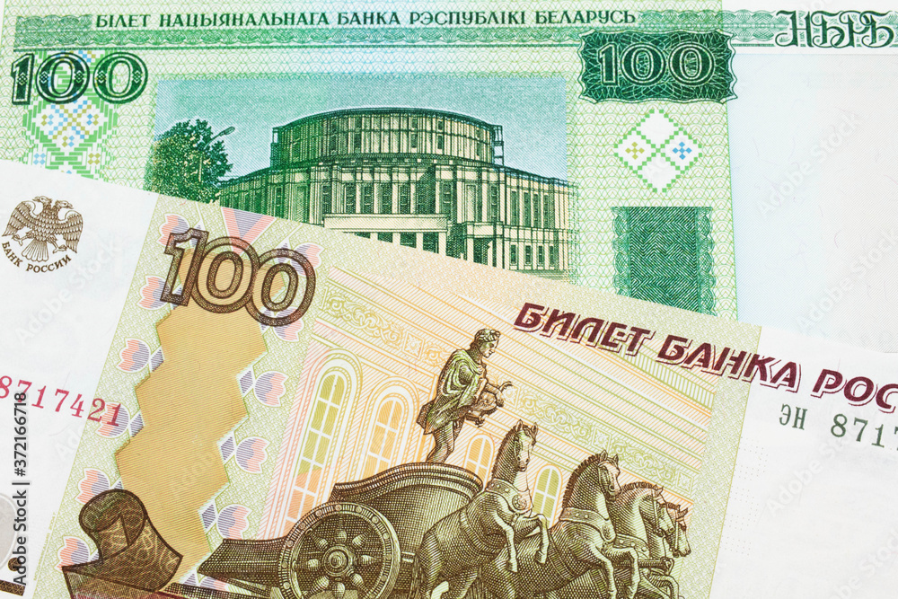 A macro image of a Russian one hundred ruble note paired up with a green one hundred ruble note from Belarus.  Shot close up in macro.