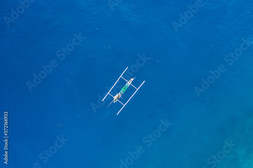 Aerial view of traditional Indonesian fishing boat in the ocean