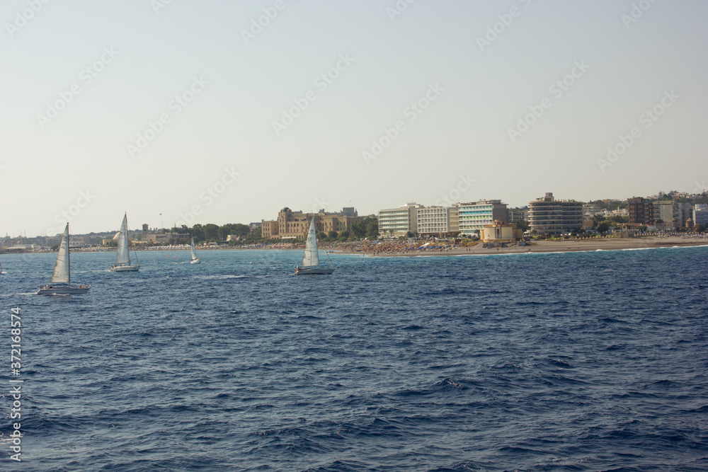 Greece. Rhodes island. Rest at the sea. Euro-trip. Sea water surface. Mountains in the background.