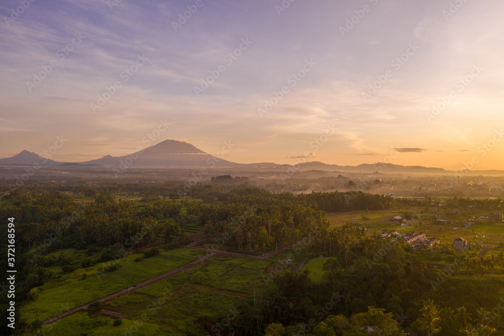 Fototapeta premium Sunrise landscape on Bali island. View of mountains, Ubud village, rice fields.