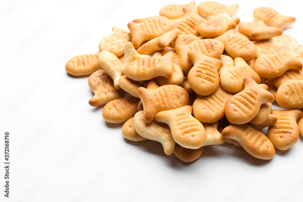 Fototapeta premium Delicious crispy goldfish crackers on white background, closeup