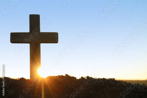 Obraz na plátne Wooden Christian cross outdoors at sunrise, space for text