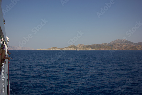 Greece. Rhodes island. Rest at the sea. Euro-trip. Sea water surface. Mountains in the background. © andreswestrum
