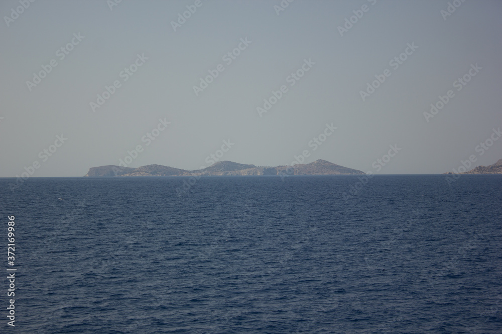 Greece. Rhodes island. Rest at the sea. Euro-trip. Sea water surface. Mountains in the background.