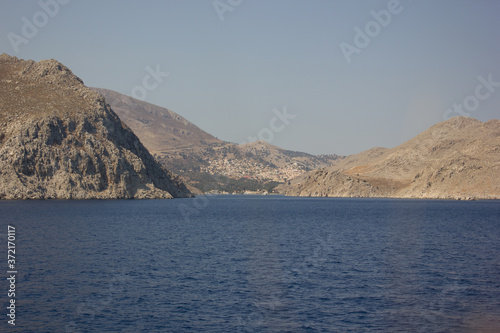 Greece. Rhodes island. Rest at the sea. Euro-trip. Sea water surface. Mountains in the background.