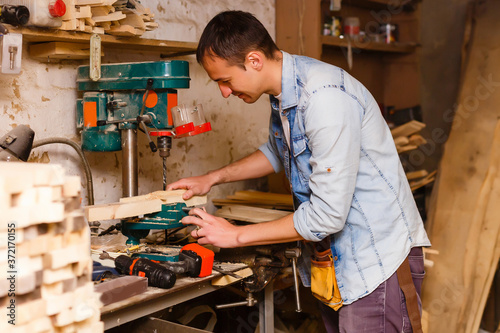 Carpenter works in a workshop for the production of vintage furniture