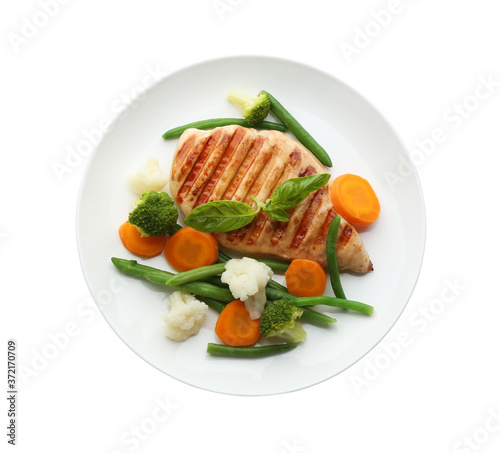 Tasty grilled chicken fillet with green basil and vegetables isolated on white, top view