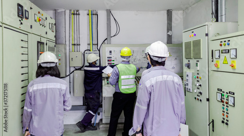 Engineers are in control room for high voltage electricity of factory, Safety patrol in manufacturing area, Cooperation by engineer and technician to check abnormality in factory