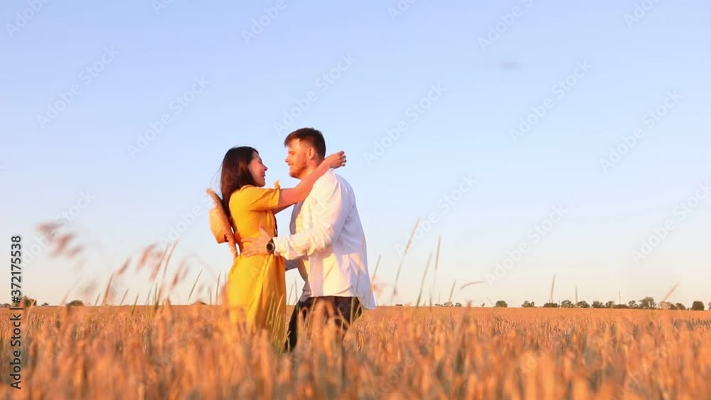 woman and man spinning on sunset at wheat field woman and man spinning on sunset at wheat field