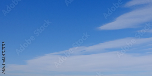 Blue spring sky with white clouds. Beautiful background.