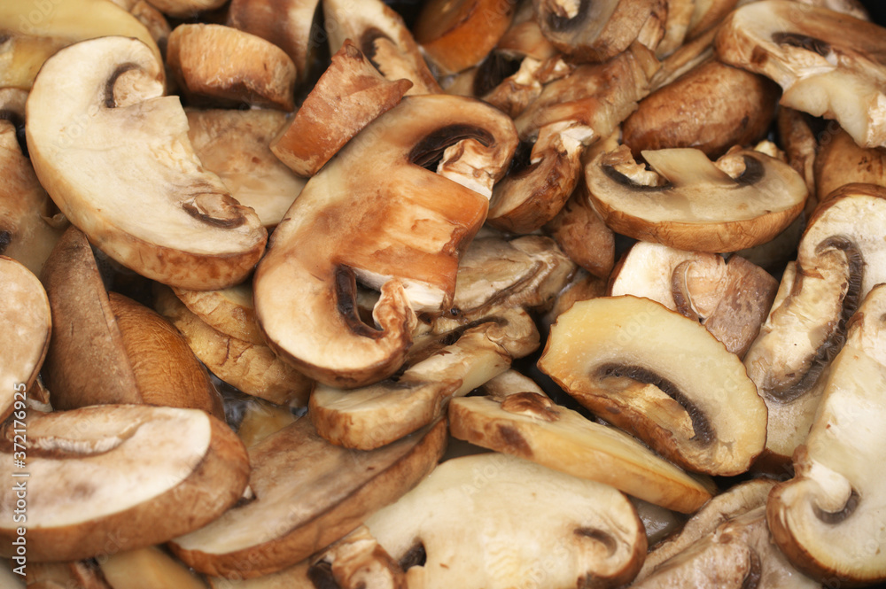Chopped champignon mushrooms frying in pan Chopped champignon mushrooms frying in pan