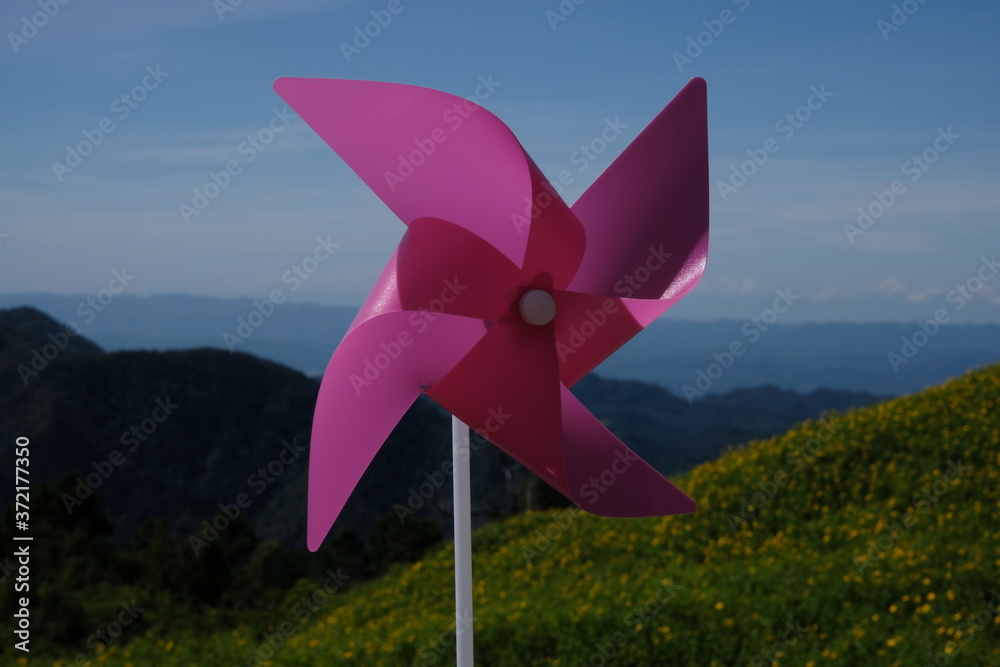 Outdoor pink windmill with mountains and sky Outdoor pink windmill with mountains and sky