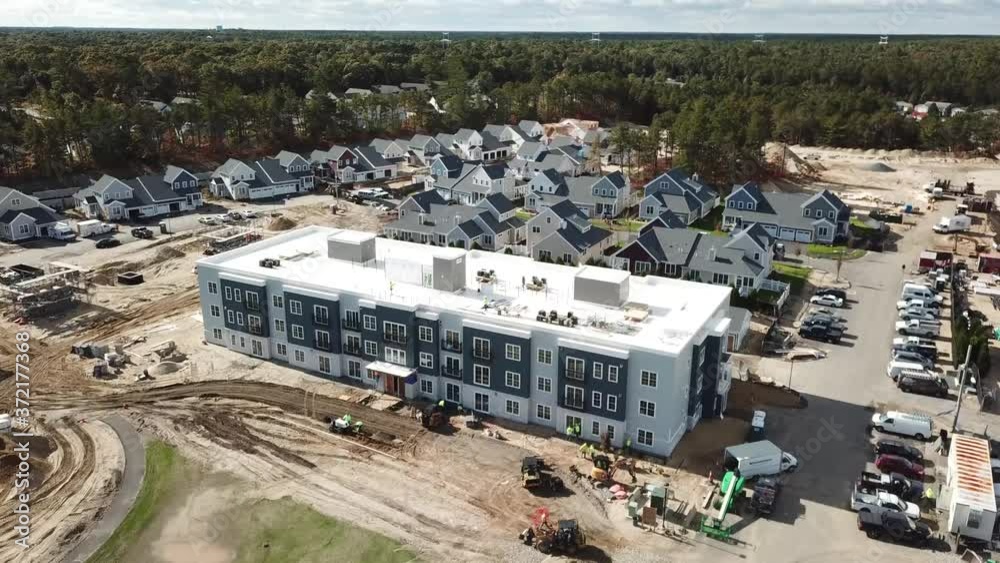 Drone shot of main building in a housing development under construction Drone shot of main building in a housing development under construction