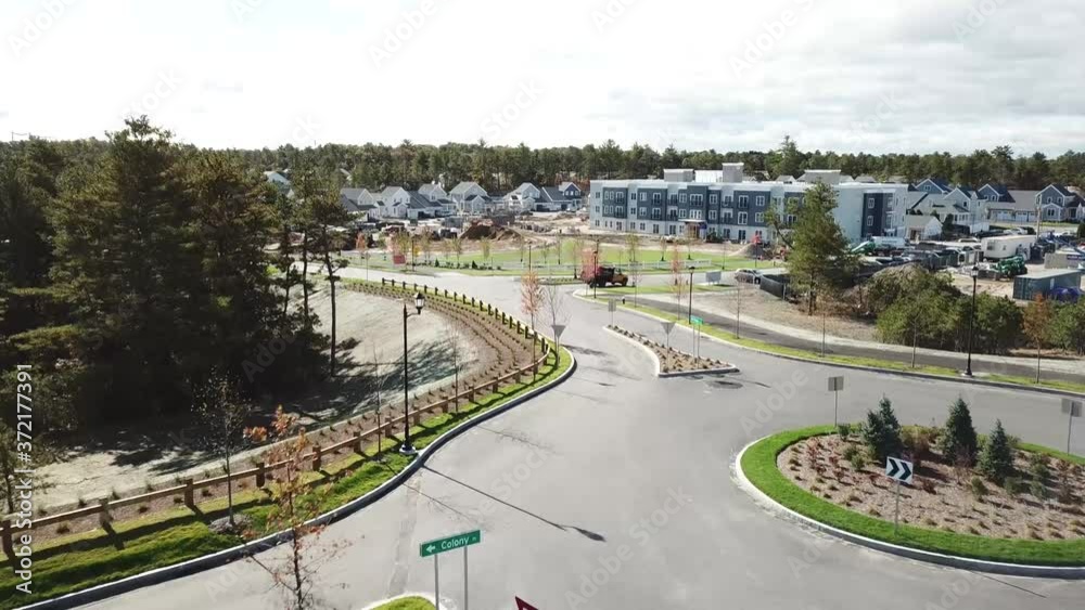 slow drone shot moving in and over a housing development under constuction slow drone shot moving in and over a housing development under constuction
