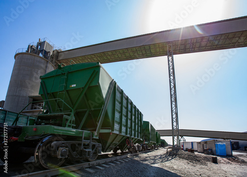 Mynaral/Kazakhstan: Modern cement plant in desert. Hopper cars on railroad terminal. Railway carriages with dry cement.
