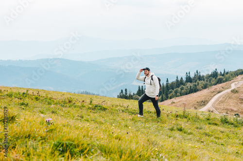 man with backpack hiking in mountains © phpetrunina14