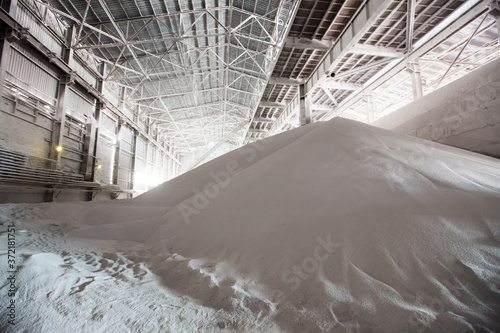 White heap or pile of salt granules (pellets) of phosphoric (phosphate) fertilizers on chemical plant. photo