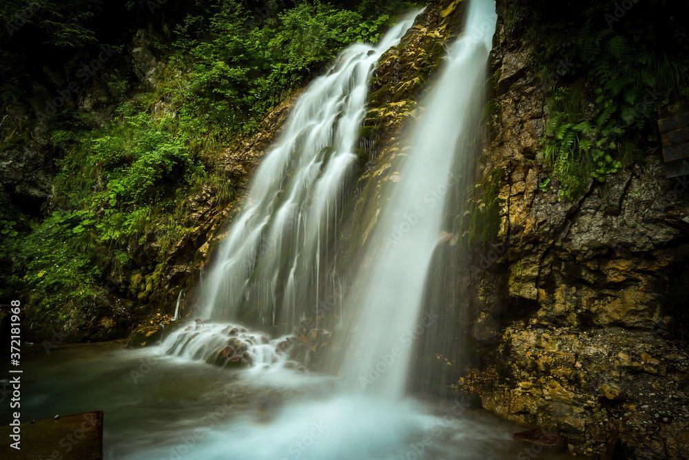 Cascada Urlatoarea Busteni (Urlatoarea waterfall) Howling in Bucegi mountains, Romania near to Sinaia. Nature wonder in the Carpathian Mountains park.