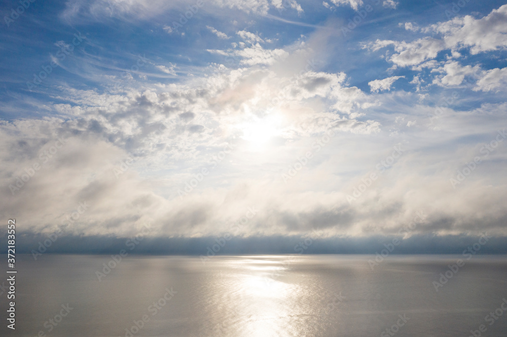 Aerial view clouds over the sea. View from drone. Aerial top view cloudscape. Texture of clouds. View from above. Sunrise or sunset over clouds. Aerial ocean background