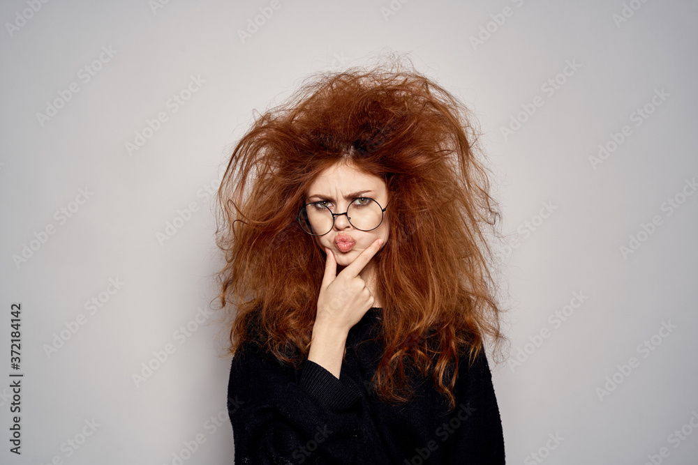 Brunette in a devil costume on Halloween red horns glasses black dress Brunette in a devil costume on Halloween red horns glasses black dress