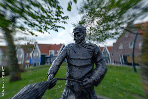 statue of a fisherman with a net in Volendam