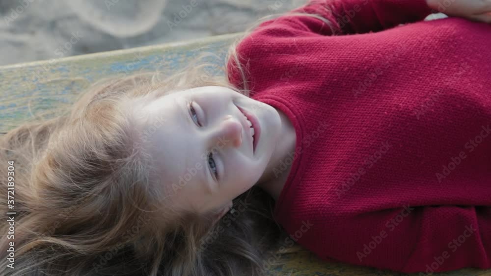 Beautiful happy girl lies on a bench. Beautiful happy girl lies on a bench.