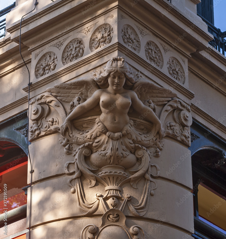 sculpture of a figurehead on the corner of a magnificent building