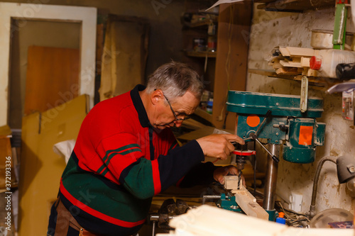 Carpenter doing his job in carpentry workshop.