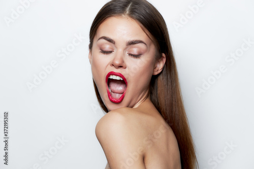 Charming woman Bare shoulders closed eyes open mouth clear skin natural look 