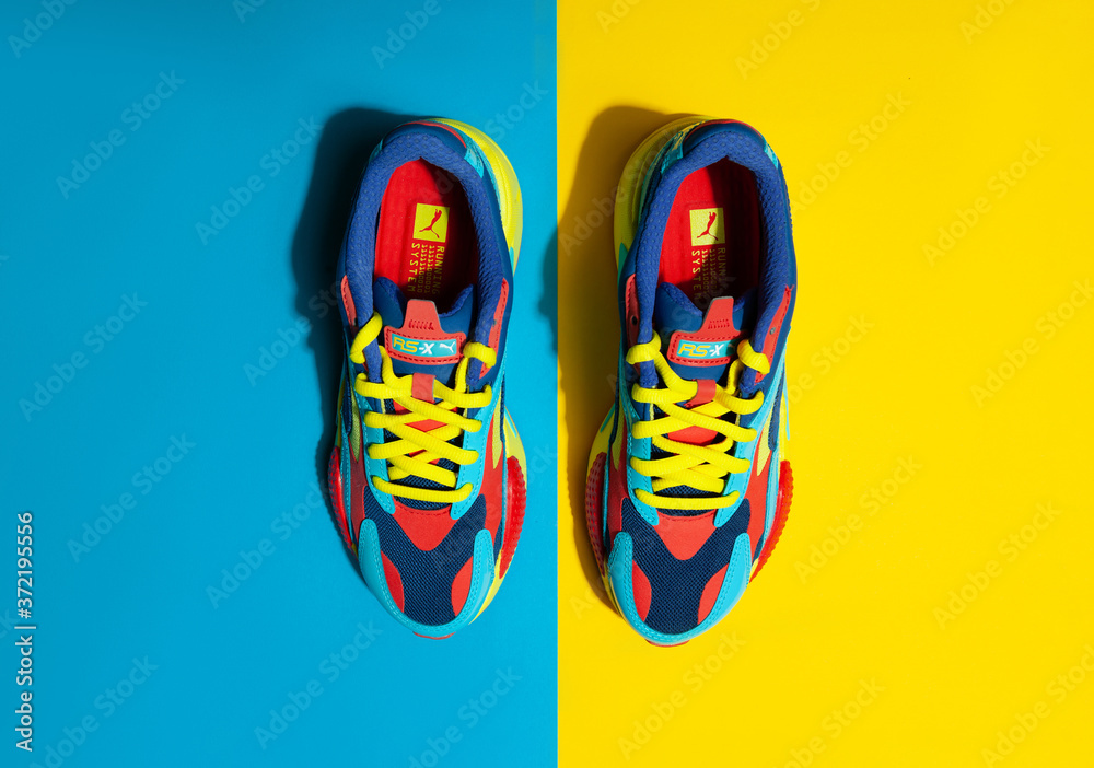 KYIV, UKRAINE - August/16/2020 : Multicolor PUMA shoes on yellow background  with shadows Stock 写真 | Adobe Stock