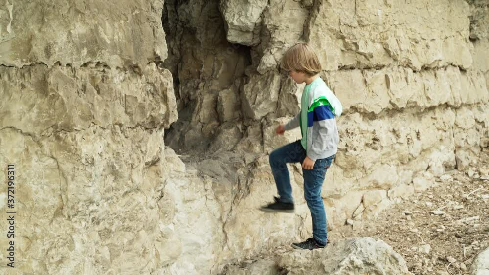 Children explore the cave. Two boys are walking in the park. Family walk with children. Children explore the cave. Two boys are walking in the park. Family walk with children.