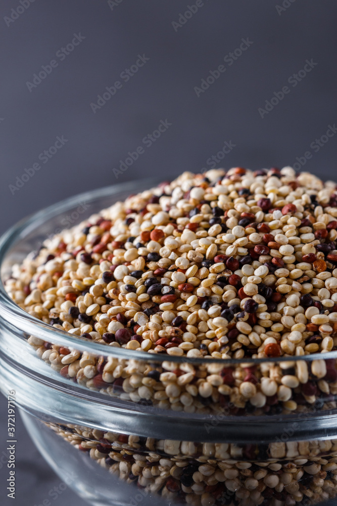 mix of quinoa grains on a dark stone background mix of quinoa grains on a dark stone background