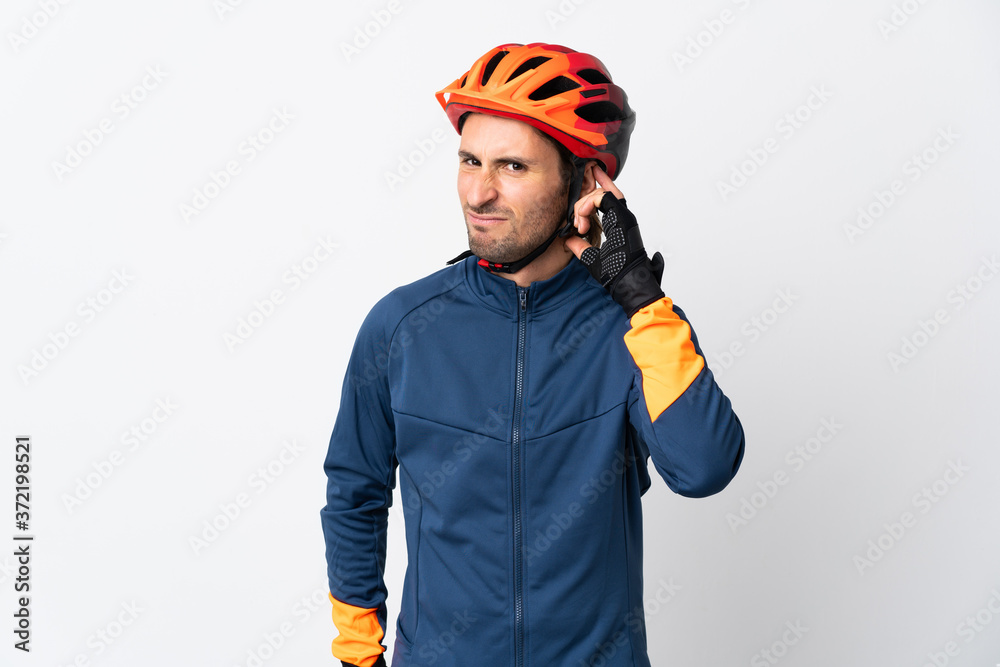 Fototapeta premium Young cyclist man isolated on white background having doubts