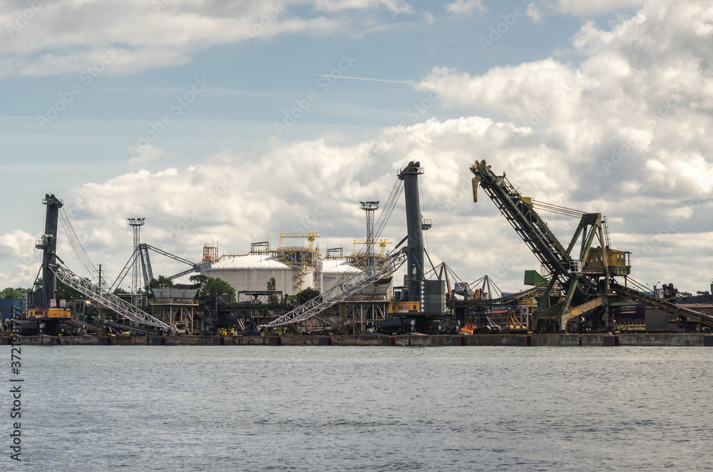 COAL TERMINAL - The transshipment quay in the seaport and the gas terminal tanks in the background