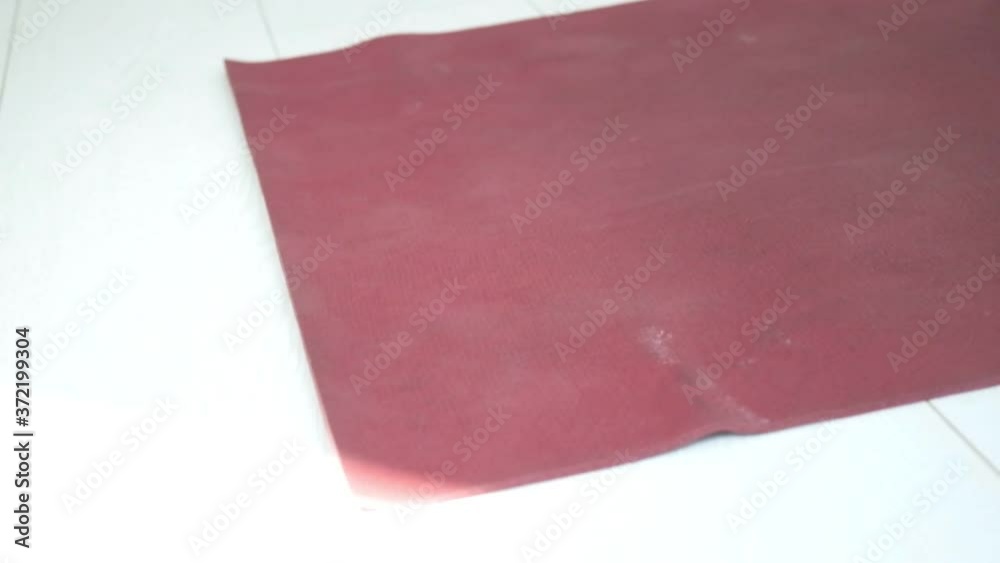 closeup on hands of young slim girl in sportswear unrolling yoga mat on floor. female preparing for pilates lesson, meditation at home, studio. sports, fitness training, stretching, workout exercises