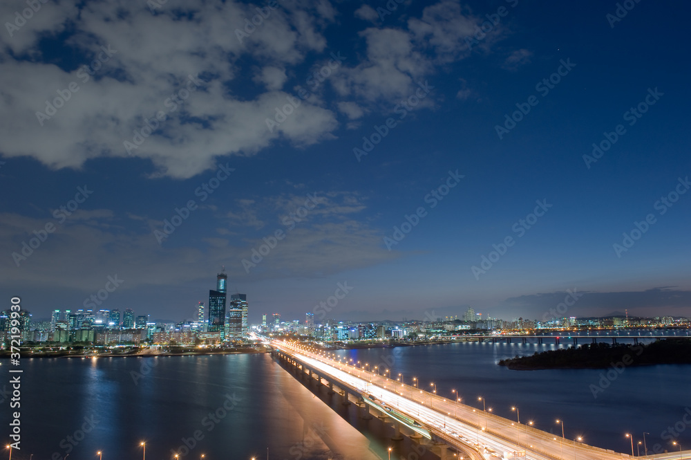 The night view of grand bridge background cityscape and blue sky.