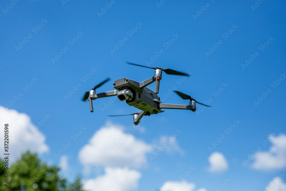 Drone quadcopter in flight over the land Drone quadcopter in flight over the land