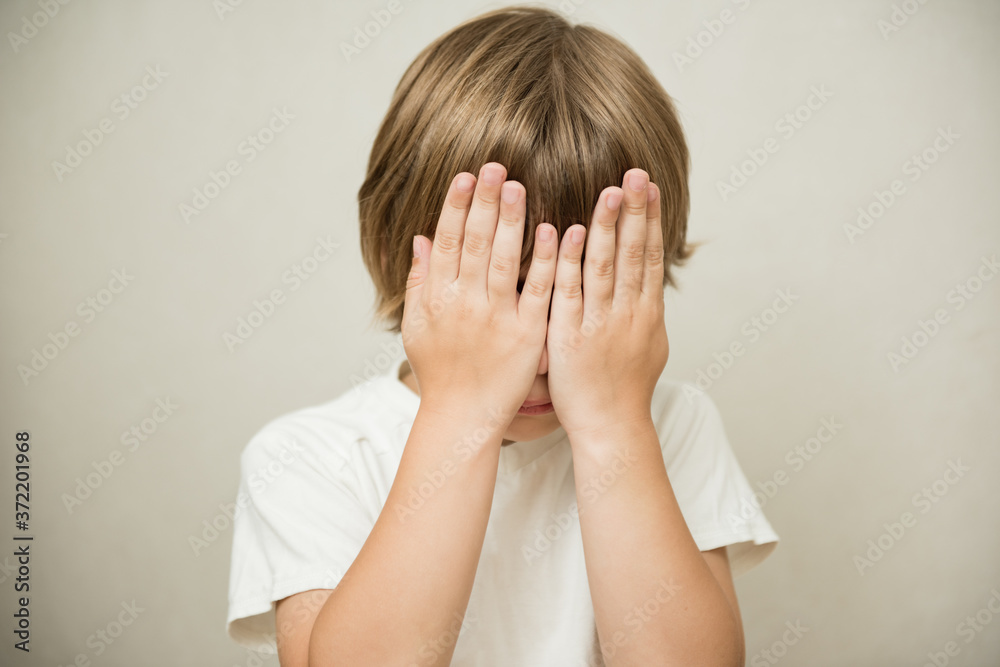 Stress and noise. The little boy closed his face Stress and noise. The little boy closed his face