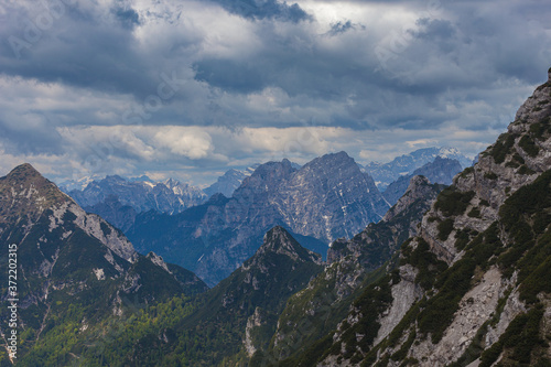 Panorama of the Cadore dolomites with cloudy sky and Monte Civetta recognizable in the background on the right. View from the East