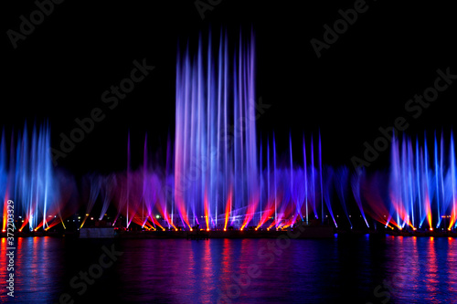 Amazing fantastic colorful fountain with blight at seaside.