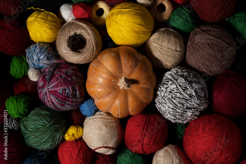 Pumpkin. Colorful balls of wool. Top view.