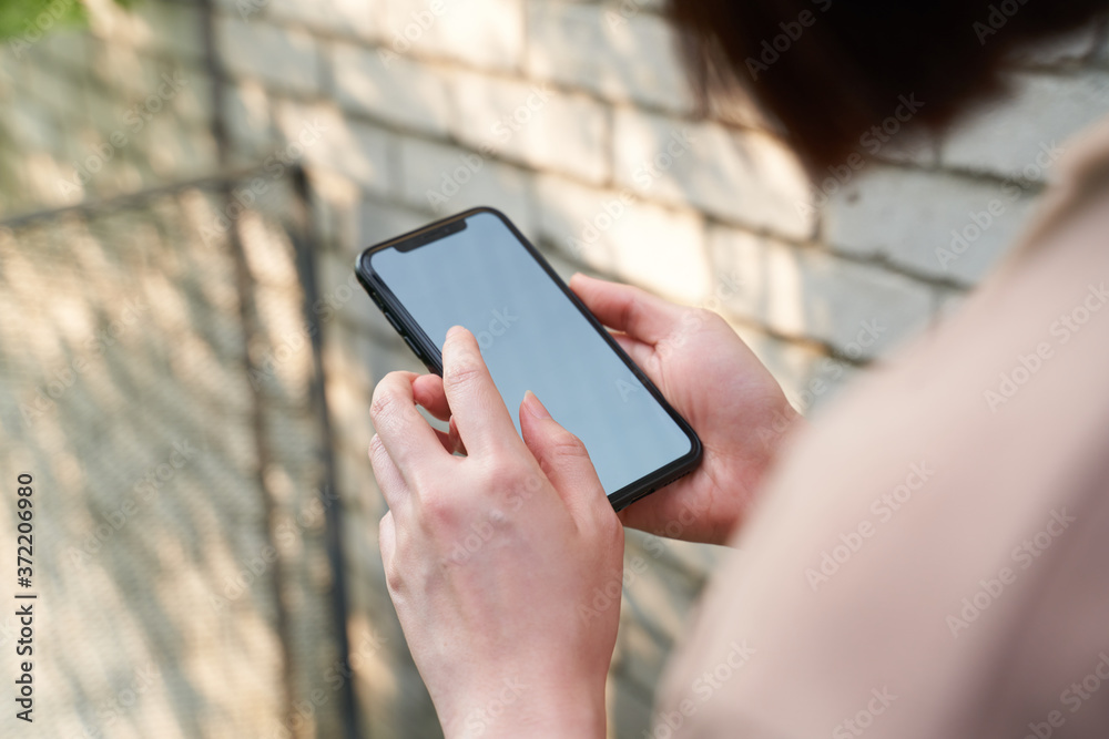 Female holding blank screen phone