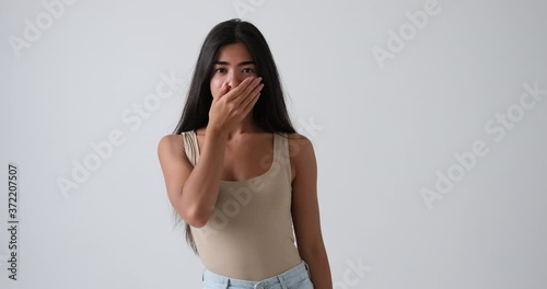 Shocked african american woman expressing displeasure over white background