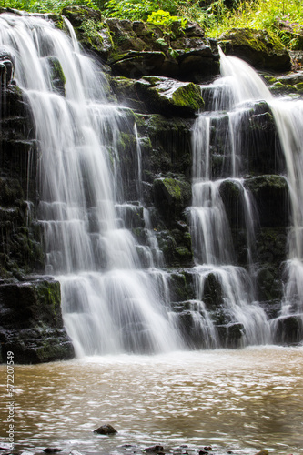 Hidden waterfall in a deep gorge with trickling white water. Forest of Bowland  Ribble Valley  Lancashire