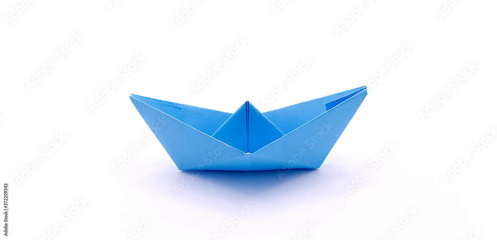 Paper boat made of colored paper close-up on a white background Paper boat made of colored paper close-up on a white background