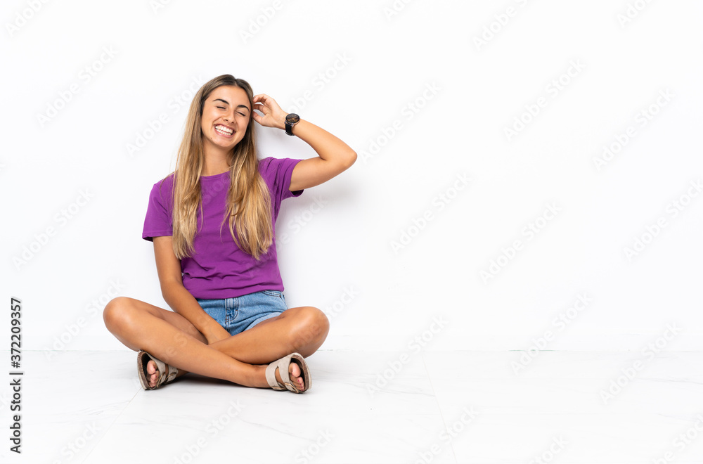 Young hispanic woman sitting on the floor smiling a lot Young hispanic woman sitting on the floor smiling a lot