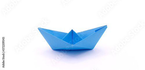 Paper boat made of colored paper close-up on a white background