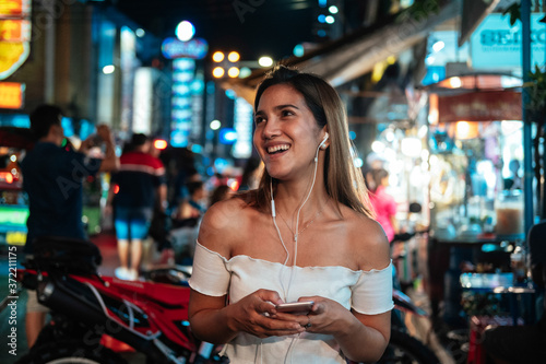 Smiling woman listening music stock photo