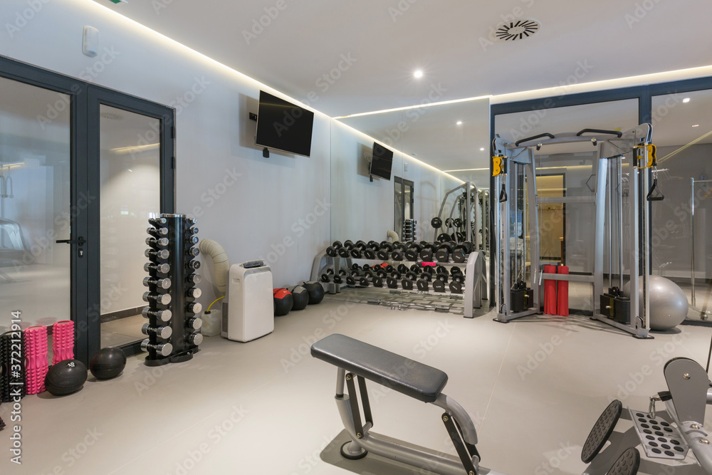 Fototapeta premium Interior of a hotel gym with equipment